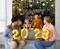 4E’s Novelty Happy New Year Banner 72” x 44” – Large Fabric New Year’s Eve Backdrop with Hanging Cord, Black & Gold Indoor Outdoor Party Decoration